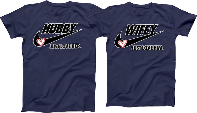 May include: Two navy blue t-shirts with a white Nike swoosh and the words "Hubby Just Love Her" and "Wifey Just Love Him" in white text. A red heart is inside the swoosh on each shirt.