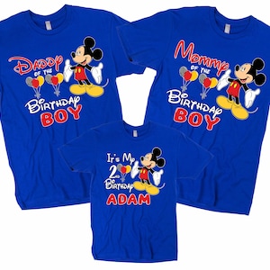 May include: Three blue t-shirts with Mickey Mouse graphics. The shirts say "Daddy of the Birthday Boy", "Mommy of the Birthday Boy", and "It's My 2nd Birthday Adam".