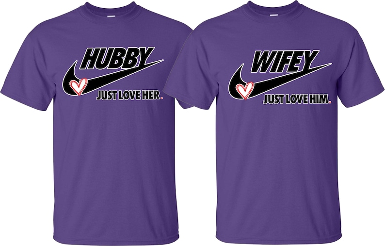 May include: Two purple t-shirts with a black Nike swoosh and the words "Hubby Just Love Her." and "Wifey Just Love Him." printed on them.