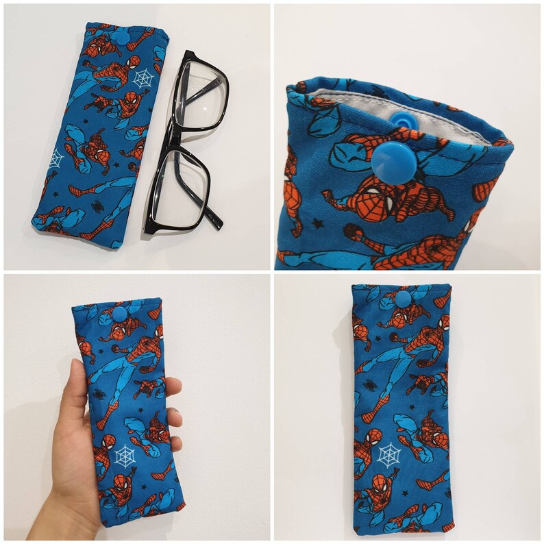 May include: A blue and red fabric glasses case with a Spiderman pattern. The case has a snap closure and a blue button.