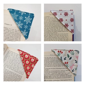May include: Four different fabric bookmark designs with a winter theme. The bookmarks are made of cotton fabric with a variety of patterns, including snowflakes, holly, and stars. The bookmarks are all triangular in shape and have a pointed tip.