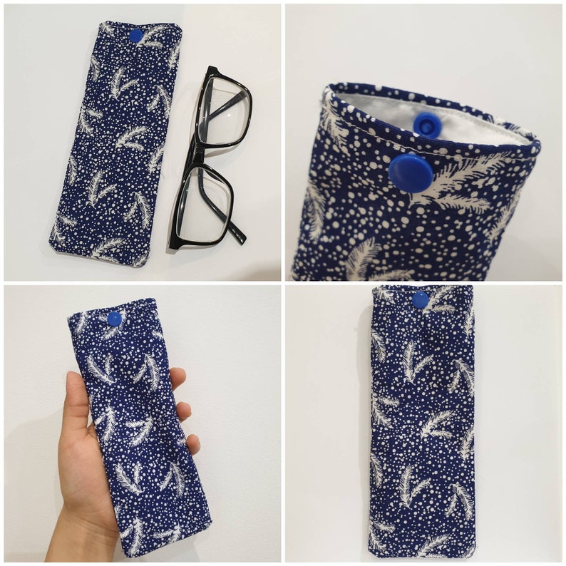 May include: A blue and white patterned glasses case with a blue button closure. The case is made of fabric and has a snowflake and leaf design.