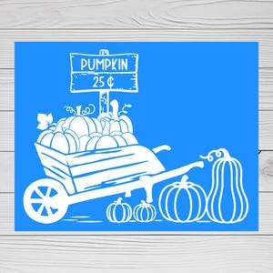 May include: A bright blue stencil featuring a white graphic of a wooden wheelbarrow filled with various pumpkins. A sign above the wheelbarrow reads PUMPKIN 25¢. Additional pumpkins are positioned on the ground next to the wheelbarrow.