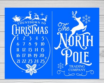 Puede incluir: Un letrero azul con temática navideña con texto blanco. El lado izquierdo dice "Countdown to Christmas" con una cuenta regresiva numerada del 1 al 25. El lado derecho dice "The North Pole Trading Company" con un gráfico de reno.