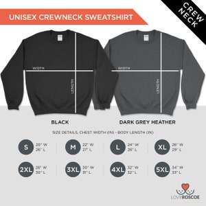 May include: Size chart for a unisex crewneck sweatshirt in black and dark grey heather. The chart shows the chest width and body length in inches for sizes S, M, L, XL, 2XL, 3XL, 4XL, and 5XL.