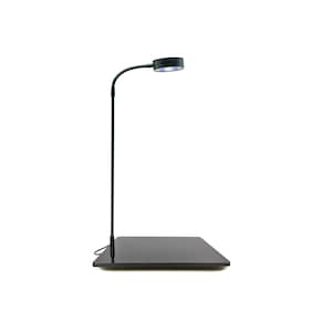 May include: A black metal plant grow light with a circular LED light head and a black base. The light is adjustable and can be positioned to provide optimal light for plants.