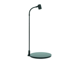 May include: A black adjustable desk lamp with a round base and a flexible arm. The lamp has a black shade with a ribbed texture.