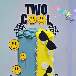 May include: A two-tiered cake with blue and yellow frosting, decorated with smiley faces, sunglasses, and checkered flags. The cake has the words "TWO COOL" and the names "Preston" and "Leighton" on it. The cake is decorated with yellow and teal frosting.