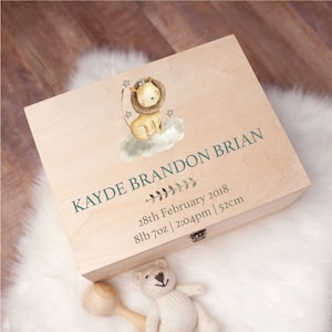 May include: A wooden keepsake box with a lion illustration and the text "KAYDE BRANDON BRIAN 28th February 2018 8lb 7oz | 2:04pm | 52cm"
