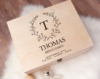 May include: A wooden keepsake box with a floral wreath design and the name "Thomas" engraved on the lid. The box also includes the baby's birth details: "Bryce Hardy, September 10th, 7lb 3oz, 4:45PM, 49CM."