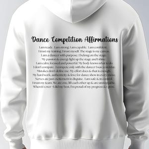 May include: White hoodie with the text "Dance Competition Affirmations" in black script. The affirmations are printed in a smaller font below the title. The hoodie is made of a soft material.