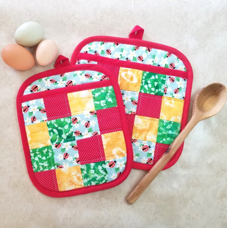 Rectangular potholders are 7 1/2 x 9 1/4 inches. Square potholders are 9 1/4 inches square.