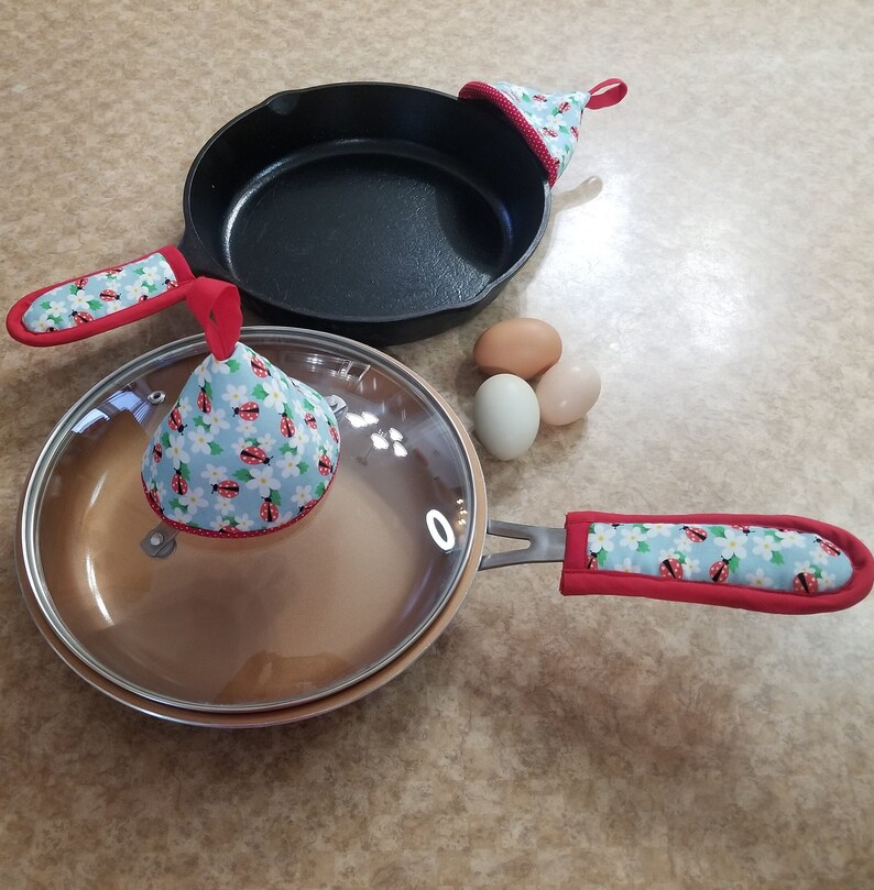 Two sizes of handle covers to fit cast iron or metal handled pans, and the lid grabbers are 4 inches tall.