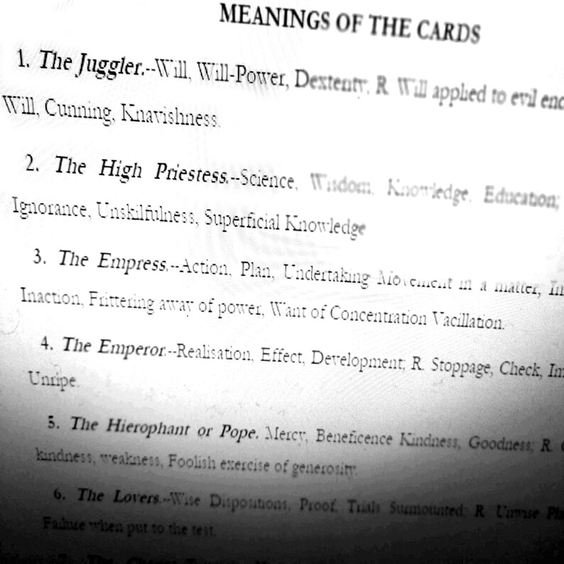May include: A black and white image of a page titled "MEANINGS OF THE CARDS." The text describes the meanings of tarot cards, including "The Juggler," "The High Priestess," and "The Empress." The text is in a serif font.
