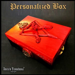 May include: A red wooden box with gold accents and a decorative red design on top. The box is labeled "Personalized Box" in an ornate font. The box is made in Italy.