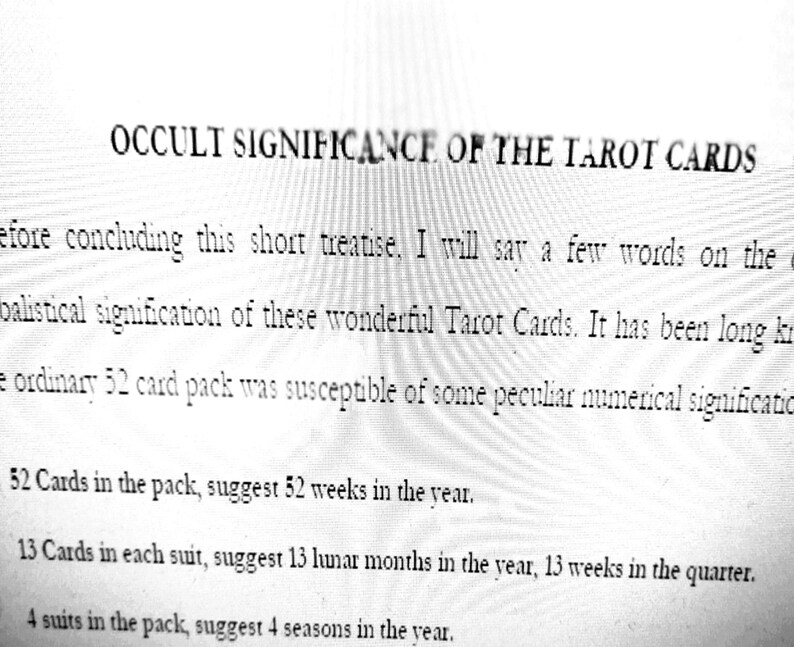 May include: A printed page with the title "OCCULT SIGNIFICANCE OF THE TAROT CARDS." The text discusses the symbolism of tarot cards, including the significance of 52 cards, 13 cards per suit, and 4 suits.