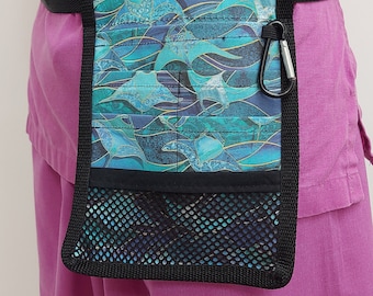 May include: A black utility belt with a blue and green patterned pouch. The pouch has a mesh pocket and a metal clip.