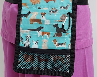 May include: A turquoise and black fabric utility belt with a mesh pocket and a dog print. The belt has a black clip and is worn around the waist.