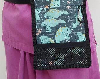 May include: A black fabric belt with a teal and black fabric pouch with a manatee print. The pouch has a mesh pocket and a black clip.