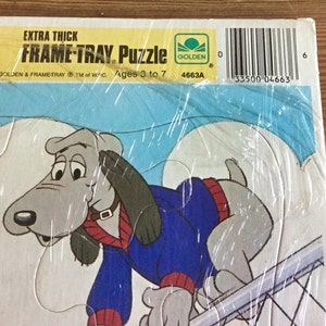 May include: A vintage Golden Books Frame-Tray puzzle featuring a cartoon dog wearing a blue sweater. The puzzle is extra thick and designed for ages 3 to 7. The box has the Golden Books logo and the text "EXTRA THICK FRAME-TRAY. Puzzle".