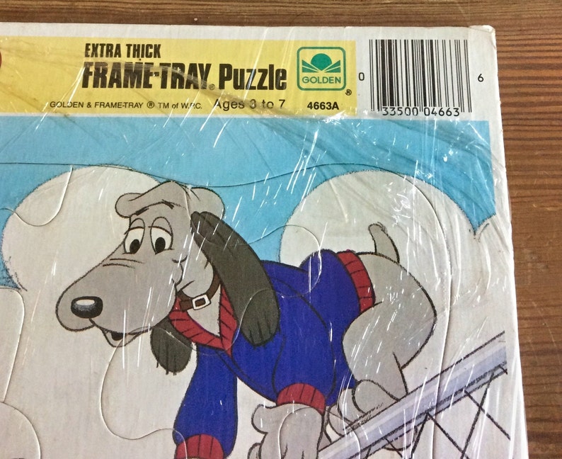 May include: A vintage Golden Books Frame-Tray puzzle featuring a cartoon dog wearing a blue sweater. The puzzle is extra thick and designed for ages 3 to 7. The box has the Golden Books logo and the text "EXTRA THICK FRAME-TRAY. Puzzle".