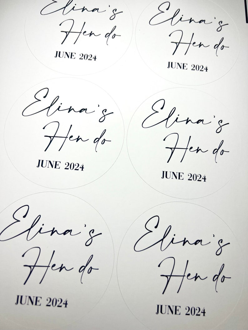 May include: Five white round stickers with black text that reads "Elina's Hen do" and "JUNE 2024".