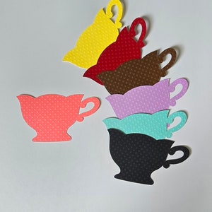 May include: Six paper teacups in various colors, including yellow, red, brown, purple, turquoise, and black. Each teacup has a white polka dot pattern.