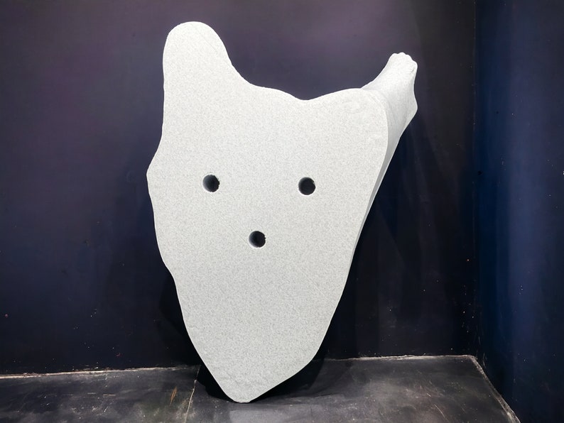 May include: A white, irregularly shaped, three-dimensional object with three circular holes. The object is made of a textured material and appears to be made of foam or a similar material.