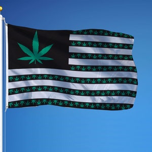 May include: A flag with a black and white striped background. The stripes are decorated with green marijuana leaf designs. A single large green marijuana leaf is in the upper left corner of the flag.