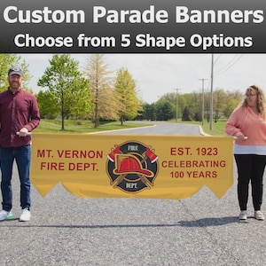 May include: A yellow banner with the text "Custom Parade Banners" and "Choose from 5 Shape Options." The banner also displays "MT. VERNON FIRE DEPT." and "EST. 1923 CELEBRATING 100 YEARS" with a fire department emblem.
