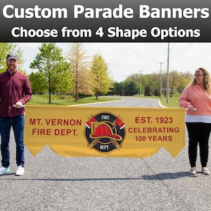 May include: A yellow parade banner with the text "Custom Parade Banners" and "Choose from 4 Shape Options." The banner reads "MT. VERNON FIRE DEPT." and "EST. 1923 CELEBRATING 100 YEARS" with a fire department emblem.