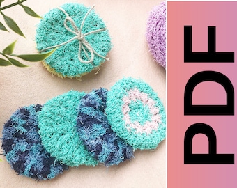 May include: Five crocheted dishcloths in various colors, including blue, green, and pink. The dishcloths are round and have a textured surface. The dishcloths are arranged in a pile on a light brown surface. The text "PDF" is visible in the upper right corner of the image.