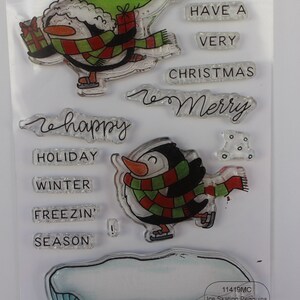 May include: Clear stamp set featuring two penguins ice skating with a red and green scarf. The set includes the text "May you have a very Christmas" and "so Merry".  The set also includes the text "Holiday", "Winter", "Freezin'" and "Season".