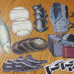 May include: A collection of vintage paper cutouts, including two baseballs, two fish, a hat, a vest, a suitcase, a pair of shoes, and two hands pointing. The baseballs are white with black stitching and the text "Wright & Ditson Regulation League Ball".