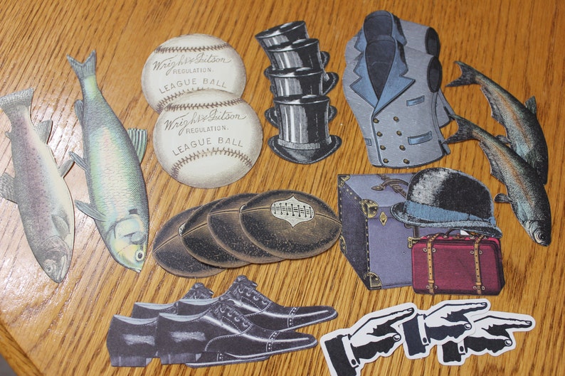 May include: A collection of vintage paper cutouts, including two baseballs, two fish, a hat, a vest, a suitcase, a pair of shoes, and two hands pointing. The baseballs are white with black stitching and the text "Wright & Ditson Regulation League Ball".