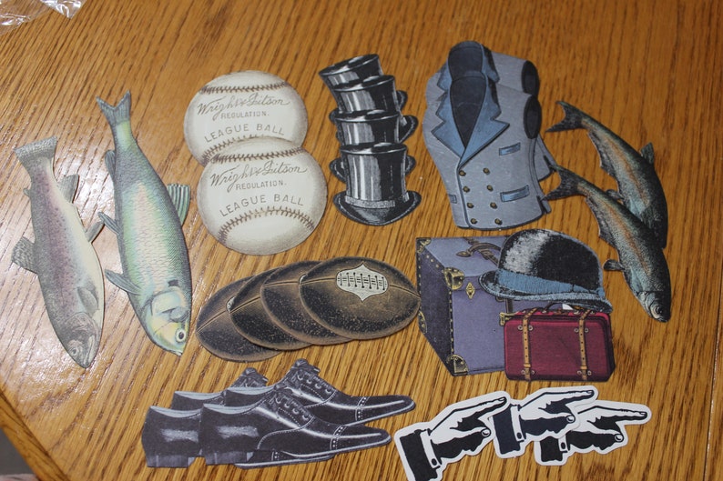 May include: A collection of vintage paper cutouts, including two baseballs with the text "Wright & Ditson Regulation League Ball", two fish, a stack of hats, a jacket, a suitcase, a bowler hat, a football, a pair of shoes, and two pointing hands.
