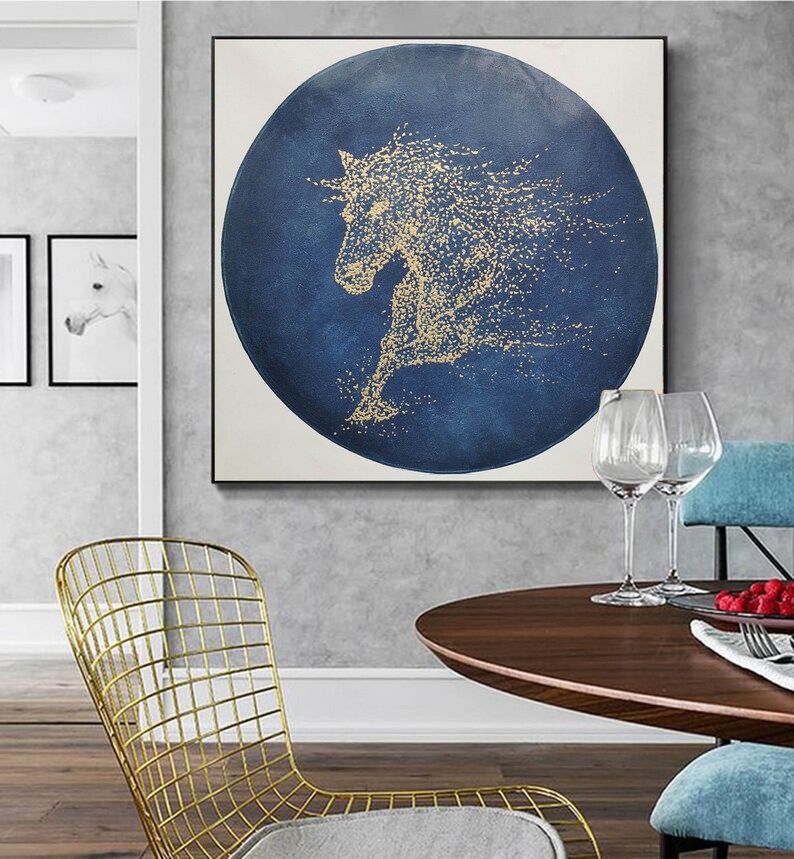 May include: A gold horse silhouette on a blue circular background. The horse is made of small gold dots and is running. The background is a dark blue with a textured look.