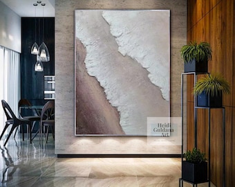 May include: Abstract painting with white and pink textured paint on a canvas. The painting is hanging on a wall in a modern home.
