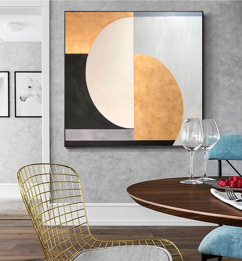 May include: Abstract geometric painting with a black, white, gold, and gray color scheme. The painting features a large circle with a smaller circle inside, and a series of geometric shapes.