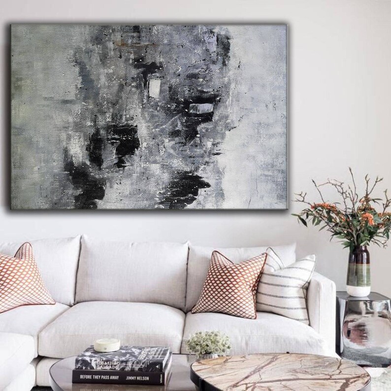 May include: Abstract painting in shades of grey and black with white accents. The painting has a textured surface and appears to be painted on canvas.