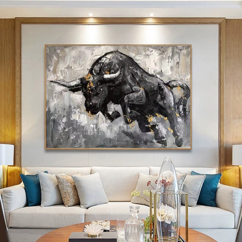 May include: A black and white abstract painting of a bull charging forward. The bull is painted in a realistic style with details of its horns, eyes, and muscles. The background is a textured gray and white.