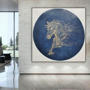 May include: Abstract painting of a horse in gold on a blue circular background. The horse is made up of small gold dots.