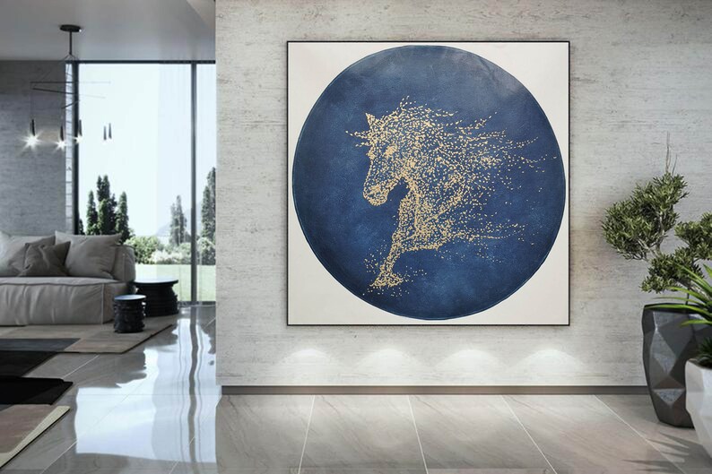 May include: Abstract painting of a horse in gold on a blue circular background. The horse is made up of small gold dots.