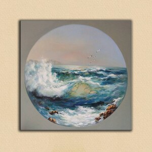 May include: A circular painting depicting a seascape with a large wave crashing against the shore. The water is a vibrant blue with white foam and the sky is a soft blue with a hint of pink. A flock of birds flies overhead.