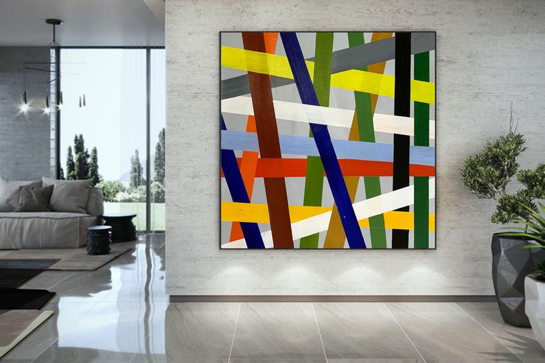 May include: Abstract painting with a geometric design featuring intersecting lines in various colors, including red, yellow, blue, green, white, and brown. The lines are arranged in a chaotic pattern on a gray background.