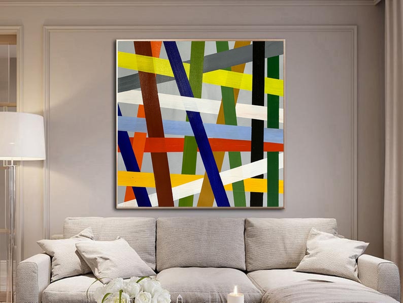 May include: Abstract painting with a geometric design featuring intersecting lines in shades of red, yellow, blue, green, white, and brown on a gray background.