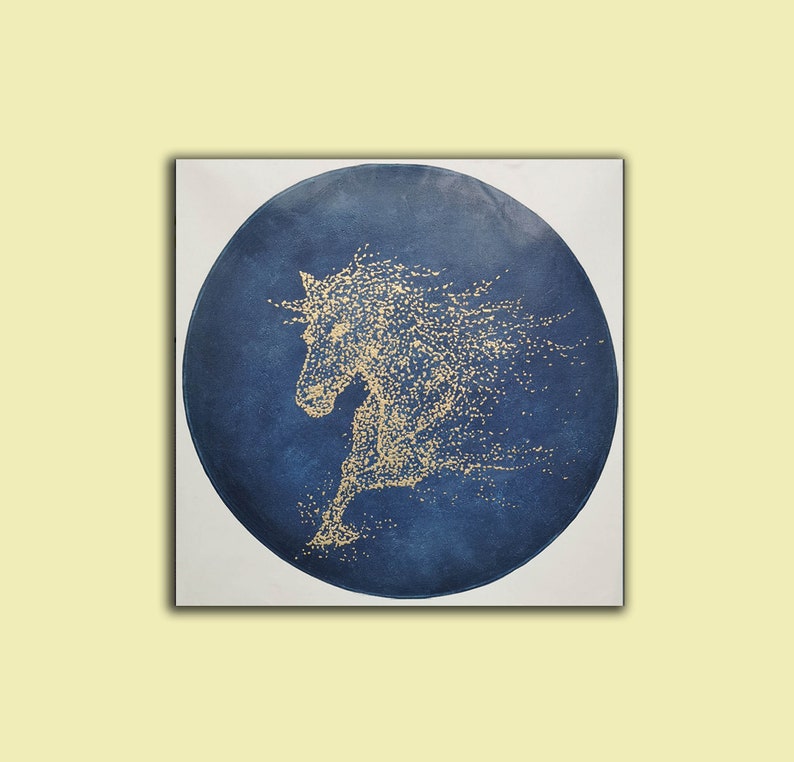 May include: A blue circular canvas painting with a gold horse silhouette in the center. The horse is depicted in a running pose with its mane flowing behind it.