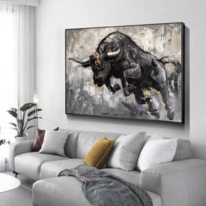 May include: A black and white abstract painting of a bull charging forward. The bull is painted in a realistic style with details of its horns, eyes, and muscles. The background is a textured gray and white with hints of gold.