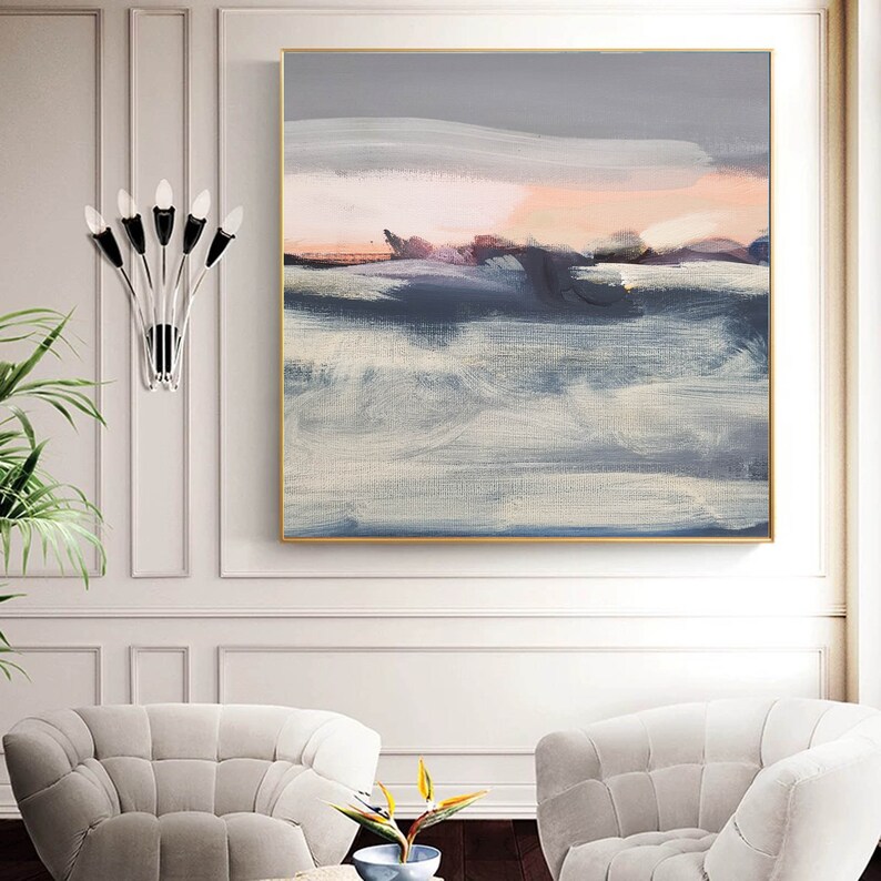 May include: Abstract painting with a gray, white, and pink color scheme. The painting depicts a landscape with a horizon line and clouds. The painting is framed in a gold frame.