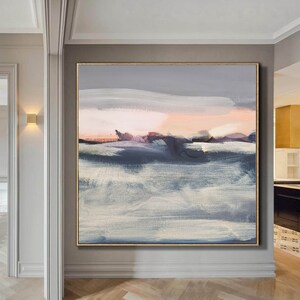May include: Abstract landscape painting with shades of gray, white, and pink. The painting features brushstrokes and a horizon line with a soft, dreamy feel.